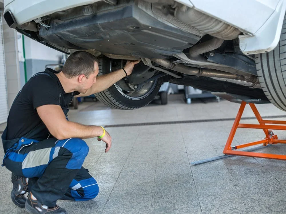 Mechanic inspecting undercarriage